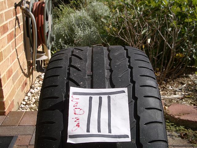 Wheel & Tire #3:  Was in the front for 12,000 miles.  Tread depth is .120-.140".  Tread bars are approximately .05