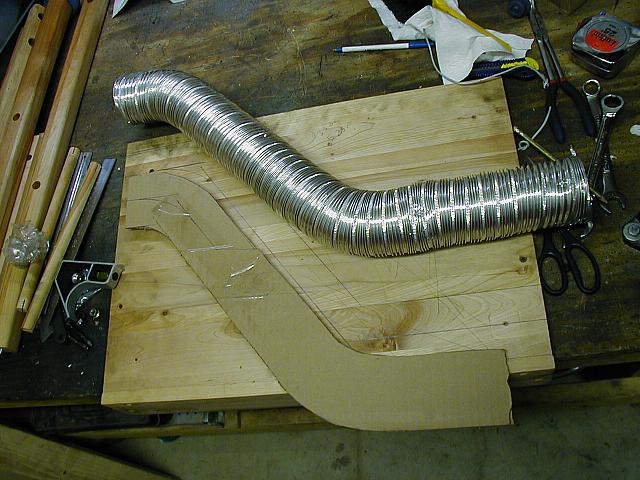 Downpipe template made with 3" rigid dryer hose transcribed to cardboard.  My brother made a technical drawing and I'm havi