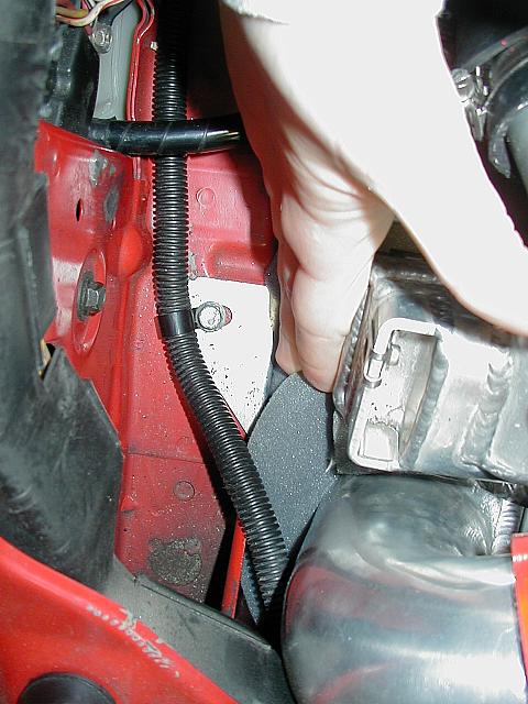 Passenger's side:  This bracket mounts the IC to the body, attached at the threaded bung on the side of the IC.