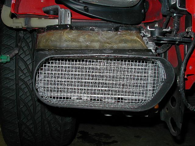 Oil cooler with straightened fins, fiberglassed duct and protective screen.